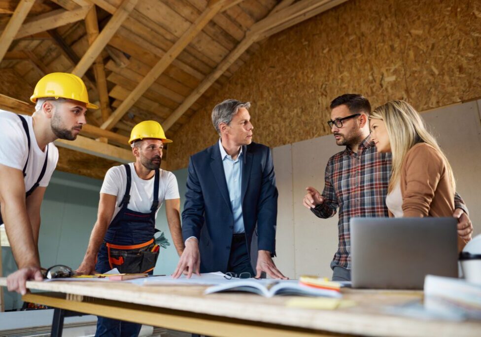 Construction team meeting discussing building plans.